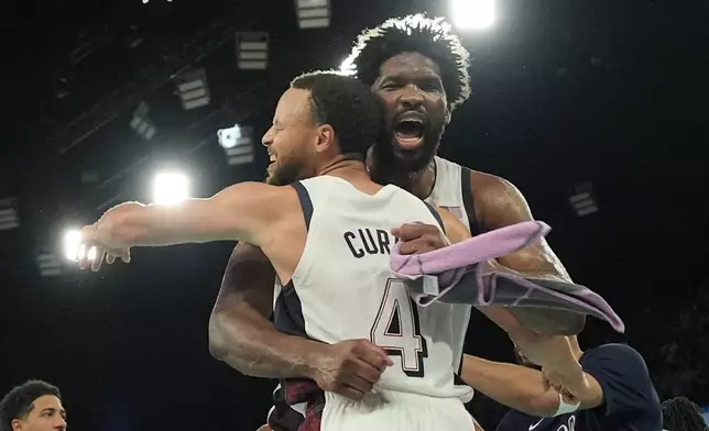 United States' Stephen Curry (4) and United States' Joel Embiid (11) celebrate after a men's semifinals basketball game against Serbia at Bercy Arena at the 2024 Summer Olympics, Thursday, Aug. 8, 2024, in Paris, France. (AP Photo/Mark J. Terrill)