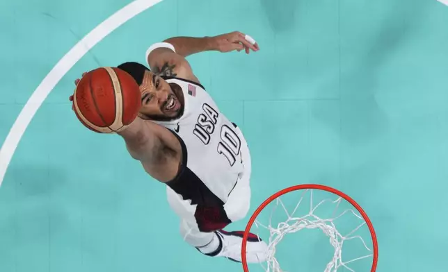 Jayson Tatum, of the United States, grabs a rebound against South Sudan at the 2024 Summer Olympics, Wednesday, July 31, 2024, in Villeneuve-d'Ascq, France. (Brian Snyder/Pool Photo via AP)