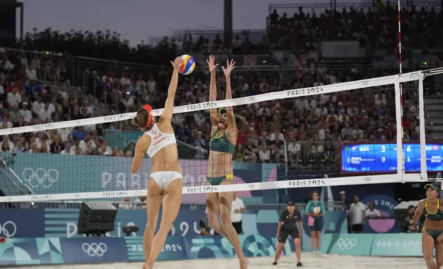 Switzerland's Tanja Hueberli hits the ball past Australia's Taliqua Clancy in the women's beach volleyball bronze medal match between Australia and Switzerland, at the 2024 Summer Olympics, Friday, Aug. 9, 2024, in Paris, France. (AP Photo/Robert F. Bukaty)