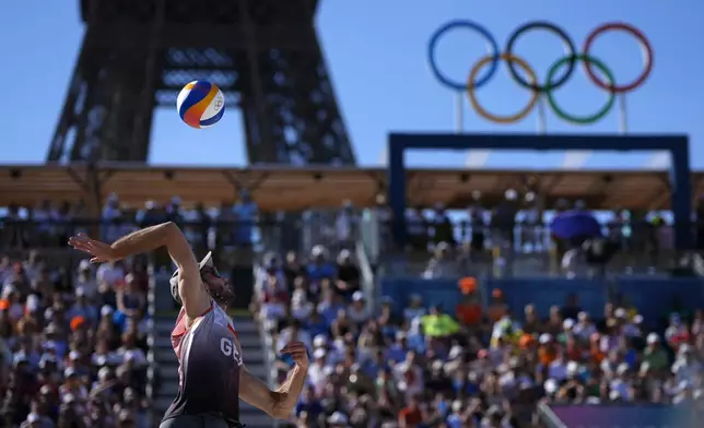 Germany's Clemens Wickler serves in a quarterfinal beach volleyball match against the Netherlands at Eiffel Tower Stadium at the 2024 Summer Olympics, Tuesday, Aug. 6, 2024, in Paris, France. (AP Photo/Robert F. Bukaty)