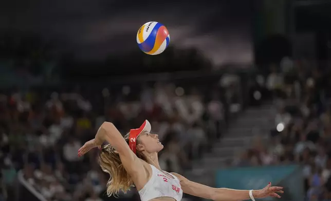 Switzerland's Nina Brunner serves in the women's beach volleyball bronze medal match between Australia and Switzerland, at the 2024 Summer Olympics, Friday, Aug. 9, 2024, in Paris, France. (AP Photo/Robert F. Bukaty)