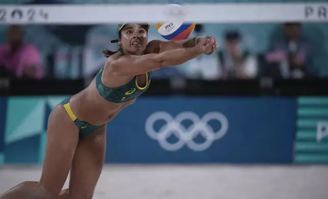 Australia's Mariafe Artacho del Solar returns a ball in the women's beach volleyball bronze medal match between Australia and Switzerland, at the 2024 Summer Olympics, Friday, Aug. 9, 2024, in Paris, France. (AP Photo/Louise Delmotte)
