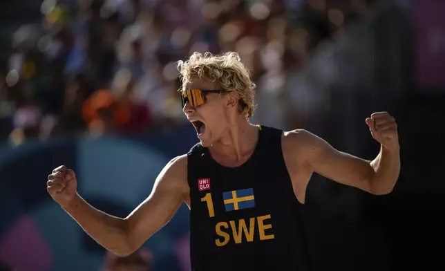 Sweden's David Ahman celebrates during the men's quarterfinal beach volleyball match between Brazil and Sweden at Eiffel Tower Stadium at the 2024 Summer Olympics, Tuesday, Aug. 6, 2024, in Paris, France. (AP Photo/Louise Delmotte)