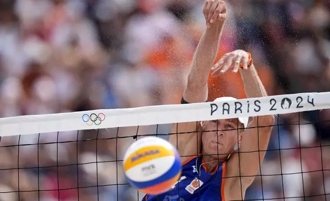 The Netherland's Steven van de Velde blocks a shot against Chile in a beach volleyball match at the 2024 Summer Olympics, Wednesday, July 31, 2024, in Paris, France. (AP Photo/Robert F. Bukaty)