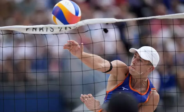 The Netherland's Steven van de Velde slams a shot over the net against Chile in a beach volleyball match at the 2024 Summer Olympics, Wednesday, July 31, 2024, in Paris, France. (AP Photo/Robert F. Bukaty)