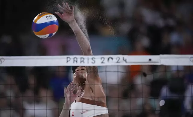 Canada's Brandie Wilkerson hits a ball in the women's beach volleyball gold medal match between Brazil and Canada, at the 2024 Summer Olympics, Friday, Aug. 9, 2024, in Paris, France. (AP Photo/Louise Delmotte)