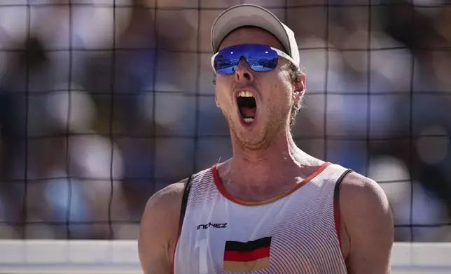 Germany's Nils Ehlers celebrates during the men's quarterfinal beach volleyball match between Germany and Netherlands at Eiffel Tower Stadium at the 2024 Summer Olympics, Tuesday, Aug. 6, 2024, in Paris, France. (AP Photo/Louise Delmotte)