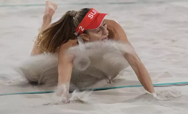 Switzerland's Nina Brunner hits the sand after returning a shot in the women's beach volleyball bronze medal match between Australia and Switzerland, at the 2024 Summer Olympics, Friday, Aug. 9, 2024, in Paris, France. (AP Photo/Robert F. Bukaty)