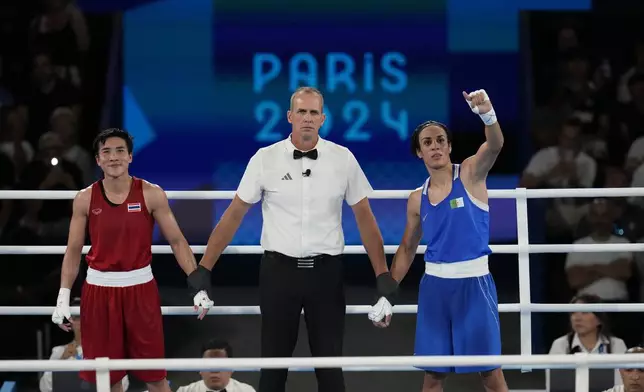 Algeria's Imane Khelif reacts after defeating Thailand's Janjaem Suwannapheng in their women's 66 kg semifinal boxing match at the 2024 Summer Olympics, Tuesday, Aug. 6, 2024, in Paris, France. (AP Photo/Ariana Cubillos)