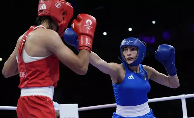 Algeria's Imane Khelif, left, fights Italy's Angela Carini in their women's 66kg preliminary boxing match at the 2024 Summer Olympics, Thursday, Aug. 1, 2024, in Paris, France. (AP Photo/John Locher)