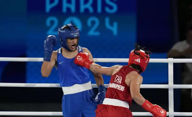 Thailand's Janjaem Suwannapheng, right, fights Algeria's Imane Khelif in their women's 66 kg semifinal boxing match at the 2024 Summer Olympics, Tuesday, Aug. 6, 2024, in Paris, France. (AP Photo/Ariana Cubillos)