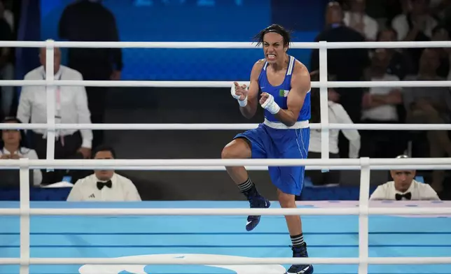 Algeria's Imane Khelif celebrates after defeating Thailand's Janjaem Suwannapheng in their women's 66 kg semifinal boxing match at the 2024 Summer Olympics, Tuesday, Aug. 6, 2024, in Paris, France. (AP Photo/Ariana Cubillos)