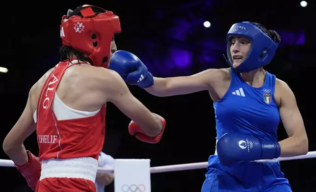 Algeria's Imane Khelif, left, fights Italy's Angela Carini in their women's 66kg preliminary boxing match at the 2024 Summer Olympics, Thursday, Aug. 1, 2024, in Paris, France. (AP Photo/John Locher)