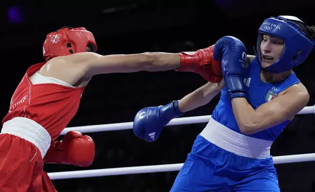 Algeria's Imane Khelif, left, fights Italy's Angela Carini in their women's 66kg preliminary boxing match at the 2024 Summer Olympics, Thursday, Aug. 1, 2024, in Paris, France. (AP Photo/John Locher)