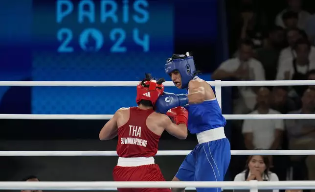 Thailand's Janjaem Suwannapheng, left, fights Algeria's Imane Khelif in their women's 66 kg semifinal boxing match at the 2024 Summer Olympics, Tuesday, Aug. 6, 2024, in Paris, France. (AP Photo/Ariana Cubillos)