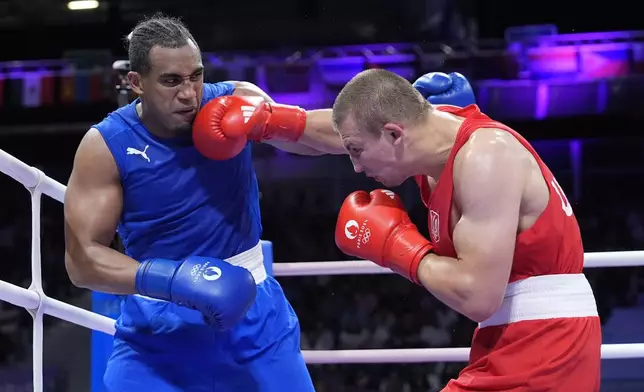 Ukraine's Oleksandr Khyzhniak hits Cuba's Arlen Lopez in their men's 80 kg semifinal boxing match at the 2024 Summer Olympics, Sunday, Aug. 4, 2024, in Paris, France. (AP Photo/Ariana Cubillos)