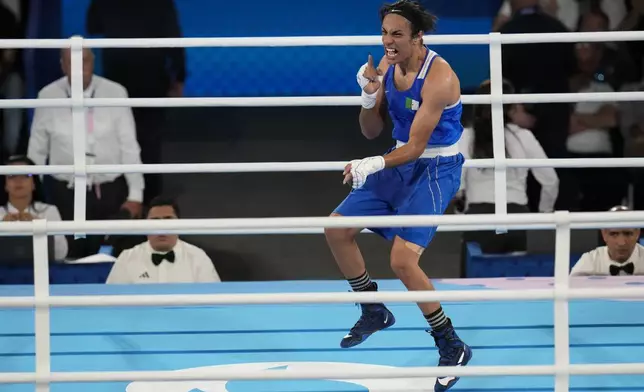 Algeria's Imane Khelif celebrates after defeating Thailand's Janjaem Suwannapheng in their women's 66 kg semifinal boxing match at the 2024 Summer Olympics, Tuesday, Aug. 6, 2024, in Paris, France. (AP Photo/Ariana Cubillos)