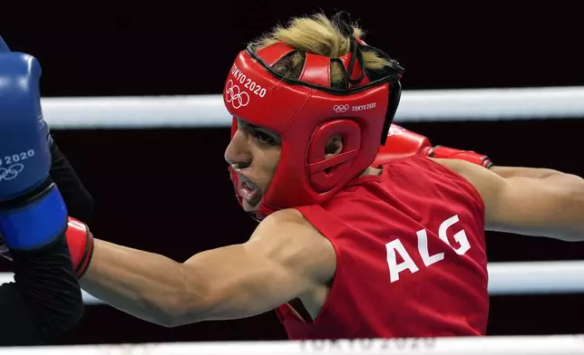 FILE - Imane Khelif, of Algeria, right, delivers a punch to Mariem Homrani Ep Zayani, of Turkey, during their women's light weight 60kg preliminary boxing match at the 2020 Summer Olympics, Friday, July 30, 2021, in Tokyo, Japan. (AP Photo/Themba Hadebe, File)