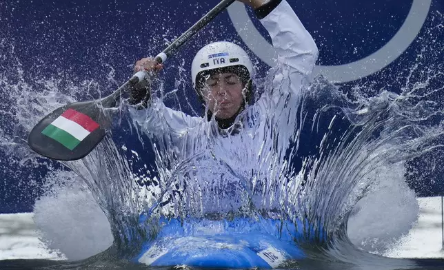 Marta Bertoncelli of Italy competes in the women's kayak cross at the 2024 Summer Olympics, Friday, Aug. 2, 2024, in Vaires-sur-Marne, France. (AP Photo/Kirsty Wigglesworth)