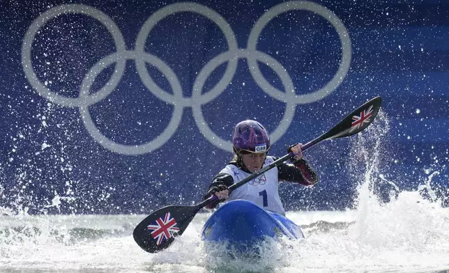 Kimberley Woods of Britain competes in the women's kayak cross time trial at the 2024 Summer Olympics, Friday, Aug. 2, 2024, in Vaires-sur-Marne, France. (AP Photo/Kirsty Wigglesworth)