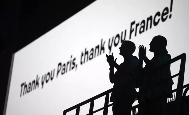 Spectators applaud during the 2024 Summer Olympics closing ceremony at the Stade de France, Sunday, Aug. 11, 2024, in Saint-Denis, France. (AP Photo/Kin Cheung)