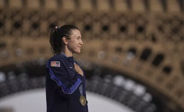 Kristen Faulkner, of the United States, winner of the gold medal of the women's road cycling event, attends the podium ceremony, at the 2024 Summer Olympics, Sunday, Aug. 4, 2024, in Paris, France. (AP Photo/Thibault Camus)