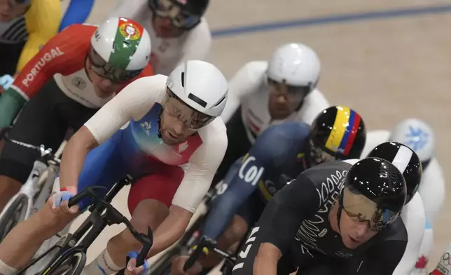 Benjamin Thomas of France, foreground left, and other competitors take part in the men's omnium event, at the Summer Olympics, Thursday, Aug. 8, 2024, in Paris, France. (AP Photo/Thibault Camus)