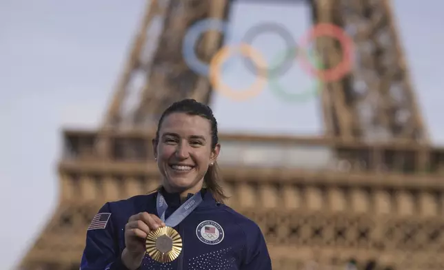 Kristen Faulkner, of the United States, poses with the gold medal of the women's road cycling event, at the 2024 Summer Olympics, Sunday, Aug. 4, 2024, in Paris, France. (AP Photo/Thibault Camus)