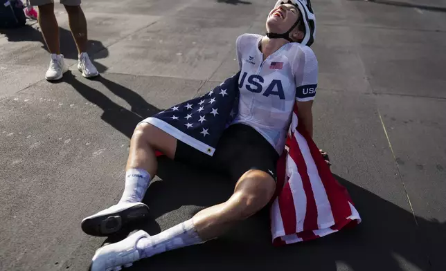 Kristen Faulkner, of the United States, celebrates winning the women's road cycling event, at the 2024 Summer Olympics, Sunday, Aug. 4, 2024, in Paris, France. (AP Photo/Thibault Camus)