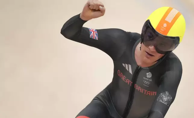 Ethan Hayter of Britain celebrates after winning the men's omnium elimination race, at the Summer Olympics, Thursday, Aug. 8, 2024, in Paris, France. (AP Photo/Thibault Camus)
