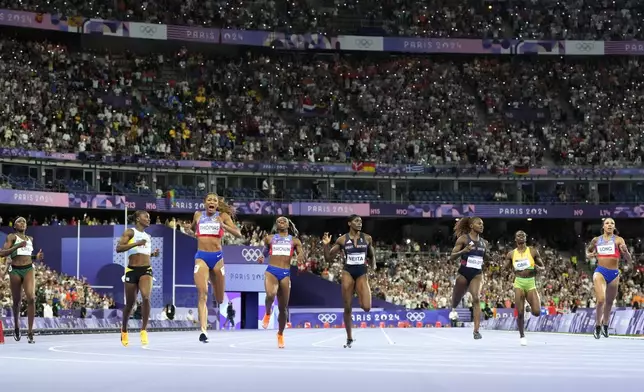 Gabrielle Thomas, third from left, of the United States, reacts after winning the women's 200-meters final at the 2024 Summer Olympics, Tuesday, Aug. 6, 2024, in Saint-Denis, France. (AP Photo/Petr David Josek)