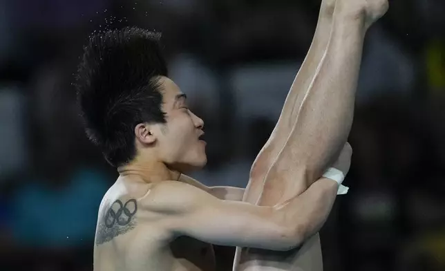 South Korea's Woo Ha-ram competes in the men's 3m springboard diving preliminary at the 2024 Summer Olympics, Tuesday, Aug. 6, 2024, in Saint-Denis, France. (AP Photo/Dar Yasin)