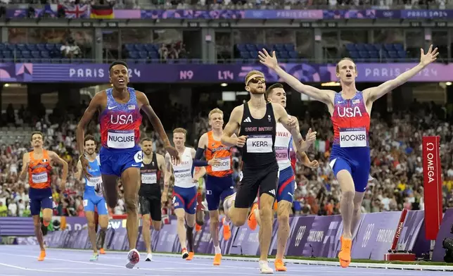 Cole Hocker, of the United States, celebrates after winning the men's 1500-meters final at the 2024 Summer Olympics, Tuesday, Aug. 6, 2024, in Saint-Denis, France. (AP Photo/Petr David Josek)