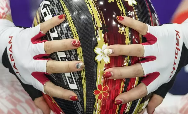 Tsuyaka Uchino of Japan adjusts her helmet before competing in the women's team pursuit event, at the 2024 Summer Olympics, Tuesday, Aug. 6, 2024, in Paris, France. (AP Photo/Thibault Camus)