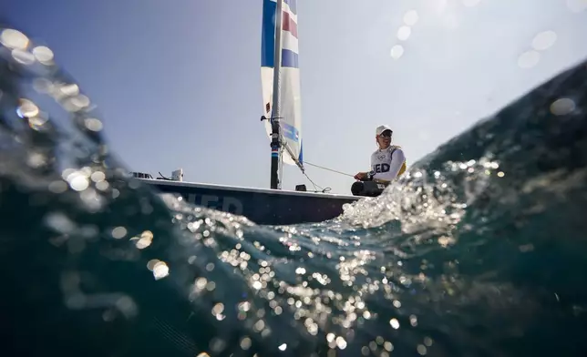 Marit Bouwmeester of the Netherlands sails back to the harbour after ILCA 6 dinghy class final race was postponed during the 2024 Summer Olympics, Tuesday, Aug. 6, 2024, in Marseille, France. (AP Photo/Jacquelyn Martin)