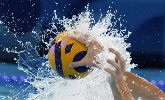 Serbia's Nikola Jaksic and Japan's Taiyo Watanabe battle for the ball during the men's Water Polo Group B preliminary match between Serbia and Japan at the 2024 Summer Olympics, Sunday, July 28, 2024, in Saint-Denis, France. (AP Photo/Luca Bruno)