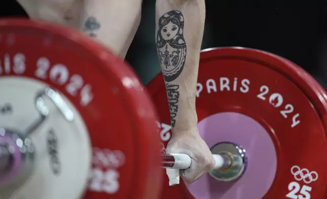 Ivan Petkov Dimov of Bulgaria competes during the men's 61kg weightlifting event at the 2024 Summer Olympics, Wednesday, Aug. 7, 2024, in Paris, France. (AP Photo/Kin Cheung)