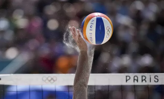 Paraguay's Giuliana Poletti reaches the ball during the women's pool D beach volleyball match between Canada and Paraguay at Eiffel Tower Stadium at the 2024 Summer Olympics, Monday, July 29, 2024, in Paris, France. (AP Photo/Louise Delmotte)