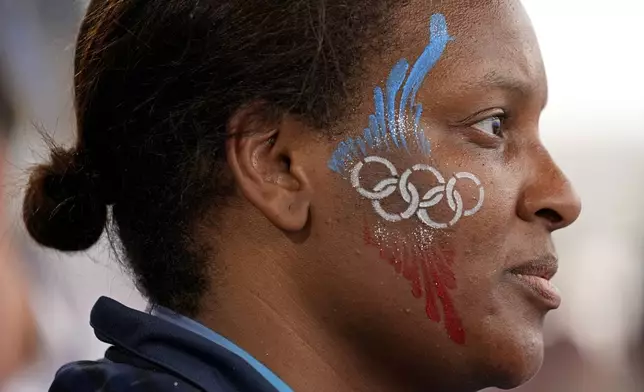 Johanna Estime watches the women's Group A field hockey match between France and China at the Yves-du-Manoir Stadium during the 2024 Summer Olympics, Saturday, Aug. 3, 2024, in Colombes, France. (AP Photo/Aijaz Rahi)