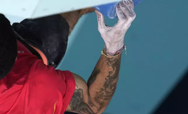 Alberto Gines Lopez of Spain competes in the men's boulder and lead, semi-final lead during the sport climbing competition at the 2024 Summer Olympics, Wednesday, Aug. 7, 2024, in Le Bourget, France. (AP Photo/Christophe Ena, Pool)