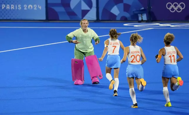 Netherlands' goalkeeper Anne Veenendaal, left, and teammates celebrate after winning the women's gold medal field hockey match against China at the Yves-du-Manoir Stadium during the 2024 Summer Olympics, Friday, Aug. 9, 2024, in Colombes, France. (AP Photo/Aijaz Rahi)