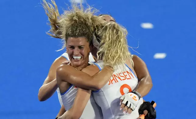 Netherlands' Yibbi Jansen, back to the camera, celebrates after scoring her side's first goal during the women's gold medal field hockey match between China and Netherlands at the Yves-du-Manoir Stadium during the 2024 Summer Olympics, Friday, Aug. 9, 2024, in Colombes, France. (AP Photo/Aijaz Rahi)