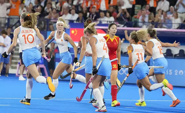 Netherlands' Yibbi Jansen, second from left, celebrates after scoring her side's first goal during the women's gold medal field hockey match between Netherlands and China at the Yves-du-Manoir Stadium during the 2024 Summer Olympics, Friday, Aug. 9, 2024, in Colombes, France. (AP Photo/ Anjum Naveed)