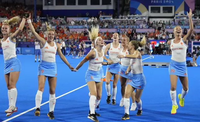 Netherlands' players celebrate after winning the women's gold medal field hockey match against China at the Yves-du-Manoir Stadium during the 2024 Summer Olympics, Friday, Aug. 9, 2024, in Colombes, France. (AP Photo/ Anjum Naveed)