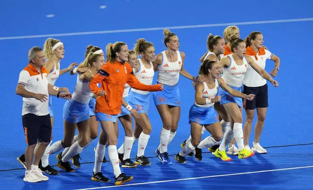Netherlands' players celebrate after seeing their teammate score the winning goal in the shootout during the women's gold medal field hockey match against China at the Yves-du-Manoir Stadium during the 2024 Summer Olympics, Friday, Aug. 9, 2024, in Colombes, France. (AP Photo/Aijaz Rahi)