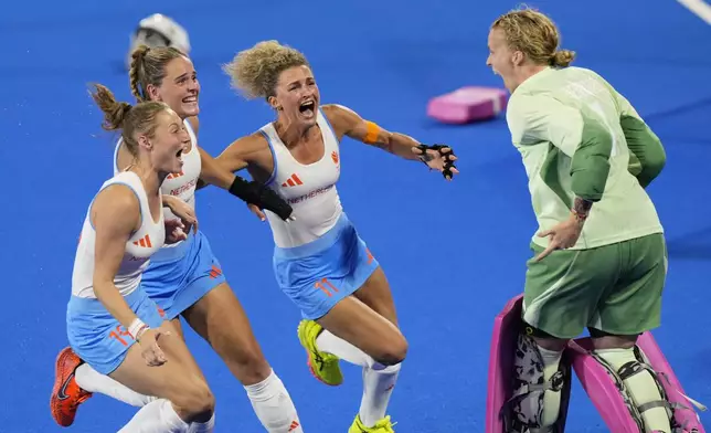 Netherlands' goalkeeper Anne Veenendaal, right, and teammates celebrate after winning the women's gold medal field hockey match against China at the Yves-du-Manoir Stadium during the 2024 Summer Olympics, Friday, Aug. 9, 2024, in Colombes, France. (AP Photo/Aijaz Rahi)