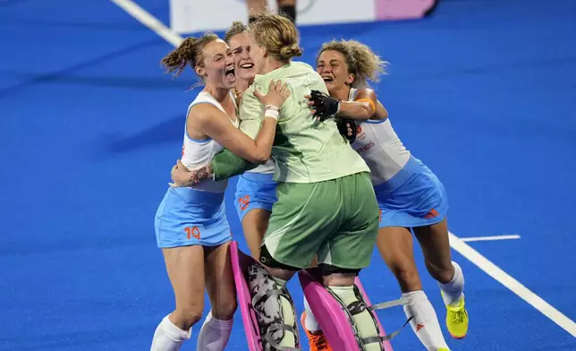 Netherlands' goalkeeper Anne Veenendaal, center, and teammates celebrate after winning the women's gold medal field hockey match against China at the Yves-du-Manoir Stadium during the 2024 Summer Olympics, Friday, Aug. 9, 2024, in Colombes, France. (AP Photo/Aijaz Rahi)