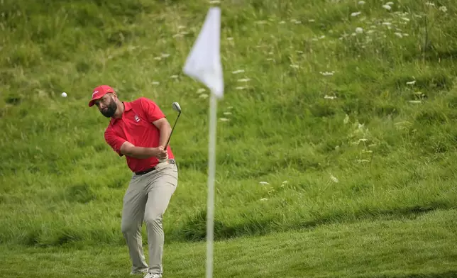 Jon Rahm, of Spain, chips onto the 14th green during the final round of the men's golf at the 2024 Summer Olympics, Sunday, Aug. 4, 2024, at Le Golf National in Saint-Quentin-en-Yvelines, France. (AP Photo/Matt York)