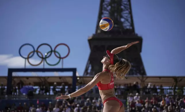 Switzerland's Nina Brunner serves during the women's semi-final beach volleyball match between Switzerland and Canada at Eiffel Tower Stadium at the 2024 Summer Olympics, Thursday, Aug. 8, 2024, in Paris, France. (AP Photo/Louise Delmotte)