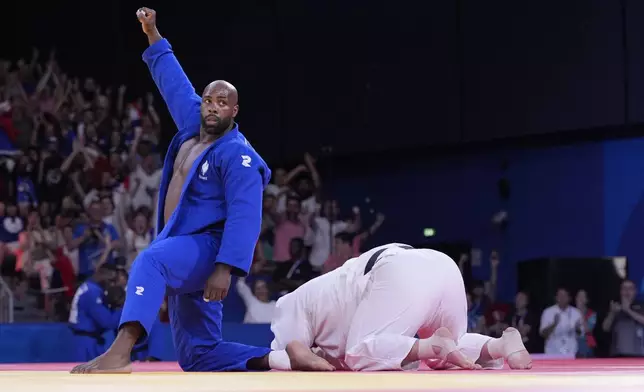 France's Teddy Riner celebrates after defeating Japan's Tatsuru Saito during men's +90 kg of the mixed team final match in the team judo competition, at Champ-de-Mars Arena, during the 2024 Summer Olympics, Saturday, Aug. 3, 2024, in Paris, France. (AP Photo/Eugene Hoshiko)